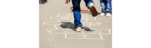 kids-playing-hopscotch-on-playground-outdoors-picture-id512047790