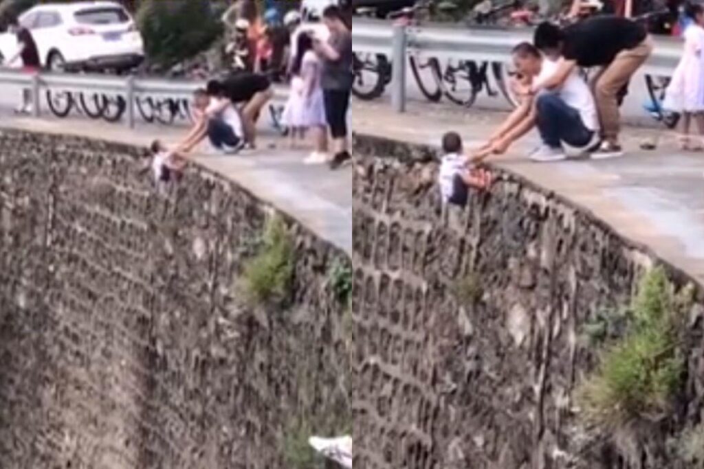 Pai conta motivo ao ser flagrado segurando filho a beira do penhasco